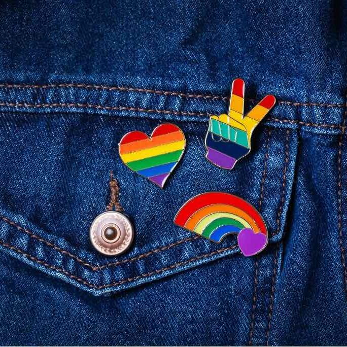 Three rainbow pins on a denim jacket. GLSEN Events